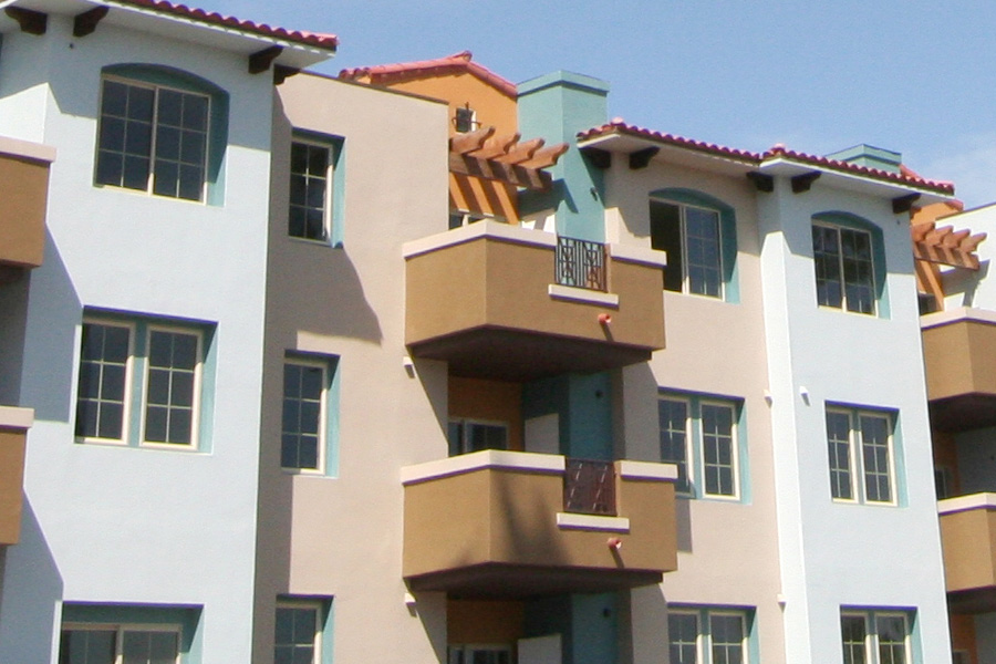 the Belasera Sherman way property building colored in light blue cream beige and dark coffee colored patios