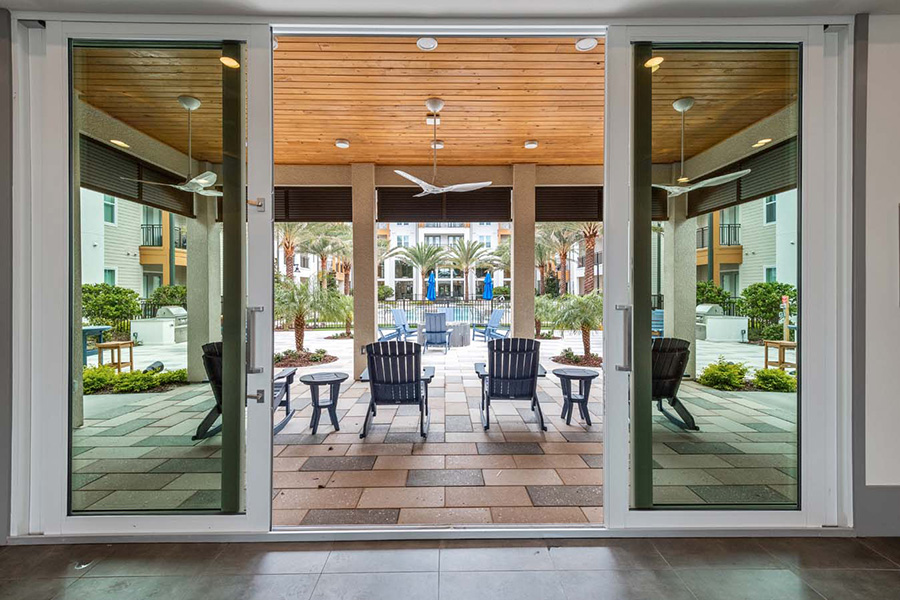 Poolside lounge with fire pit, lounge chairs, and covered lounge.